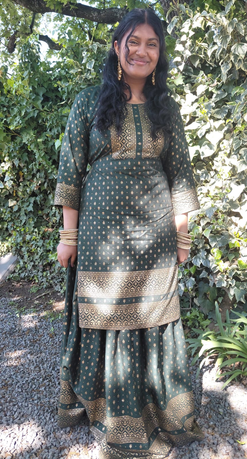 A member of the JENS family celebrating Heritage Day in traditional green and gold clothing