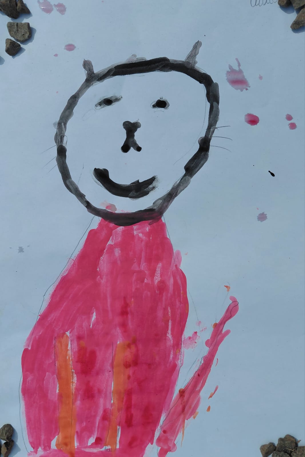 A Grade 1 learner's painting of a smiling cat with a bright pink body