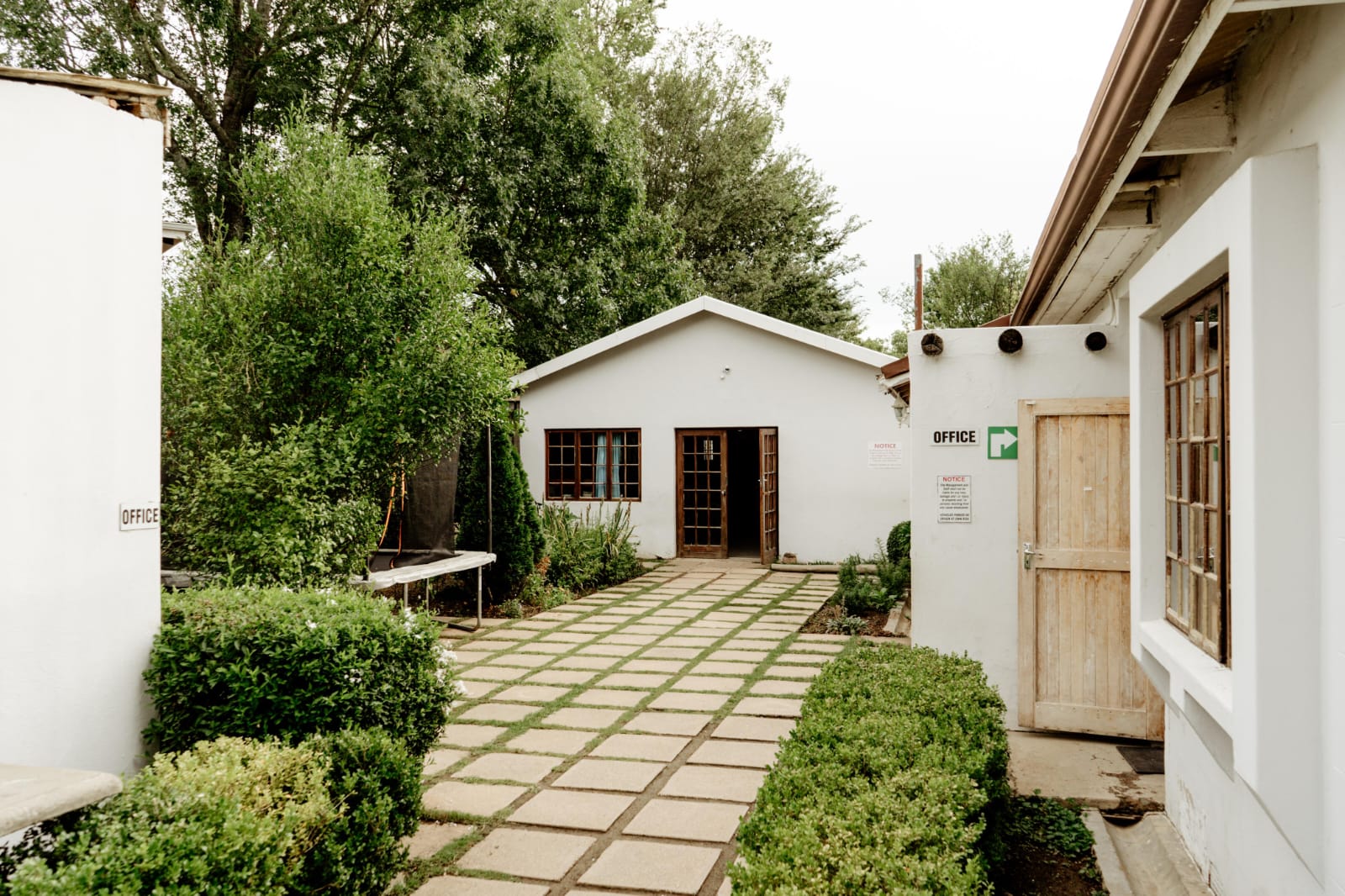 The paved courtyard and office entrance at JENS Primary School